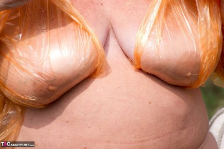 Obese oma Grandma Libby doffs a see-through raincoat to get naked on a bridge