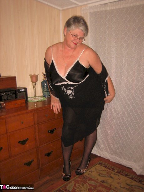 Overweight nan Girdle Goddess strips to her footwear in front of a dresser