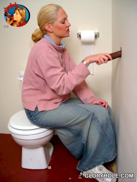 Blonde girl Jamie sits on the toilet and blows a black gloryhole dong