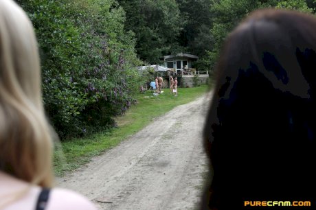 Lovely clothed female students blow off a nudist colony outdoors