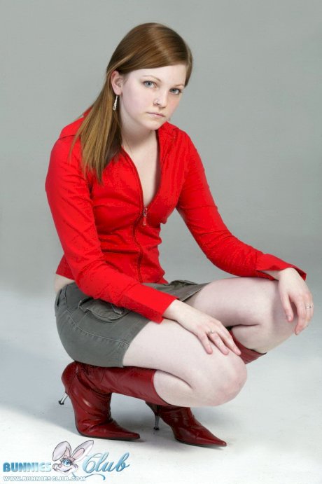 Pale redhead Lilly slowly strips to a black G-string and red leather boots