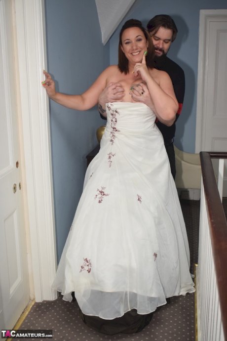 Amateur woman Sara Banks as her tits and pussy freed from a gown by two men