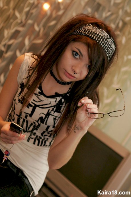 Young brunette Kaira 18 takes off her glasses while modelling non nude