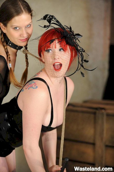 Two lesbians play lezdom sex games wearing sensual lingerie and latex clothing