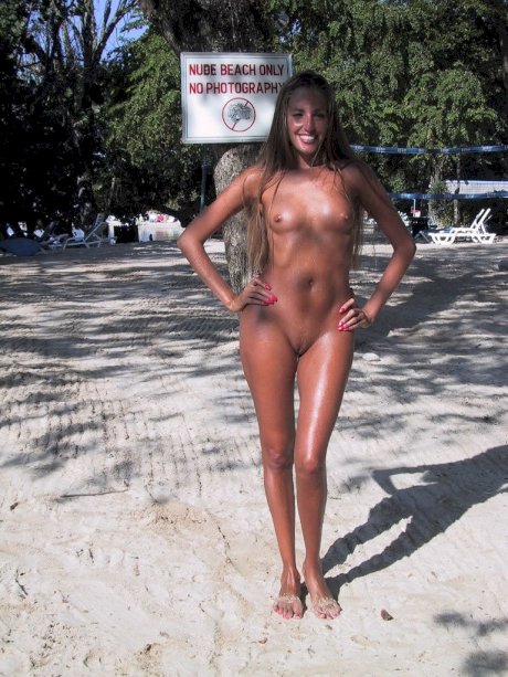 Slutty MILF Lori Anderson showing her erect nipples & her bald twat poolside
