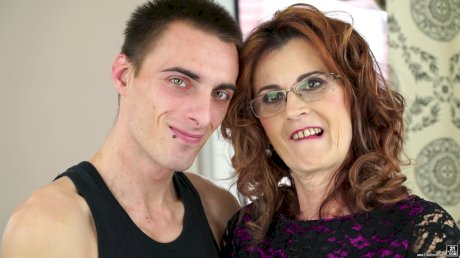 Horny granny Mayna May bangs her boy toy's big cock in glasses and mesh hose