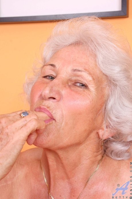 Grey haired granny Betty exposes her saggy juggs and fingers her clam