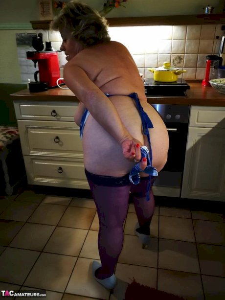 Old housewife Caro takes off her underwear in kitchen apron and stockings