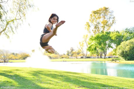 Teenage hottie in sexy outfit Zoe doing exercise outdoors by the water