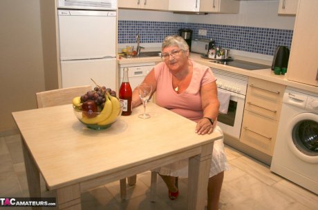 Mature BBW Grandma Libby strips in the kitchen to wine & dine & toy pussy nude