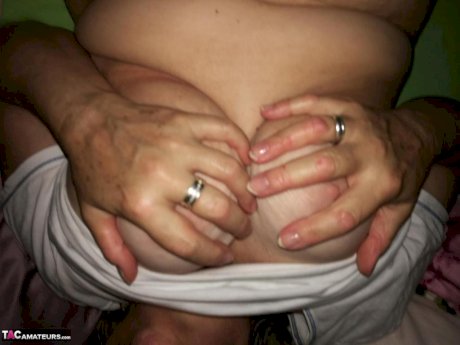 Horny older woman licks her nipple before dildoing her hairy pussy