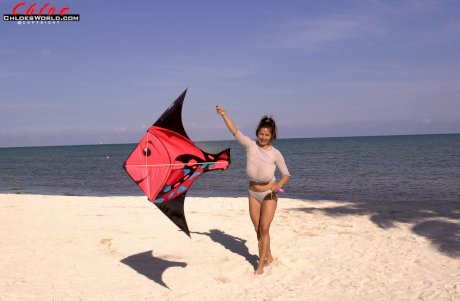 Super busty Chloe Vevrier letting her massive big tits hang loose at the beach