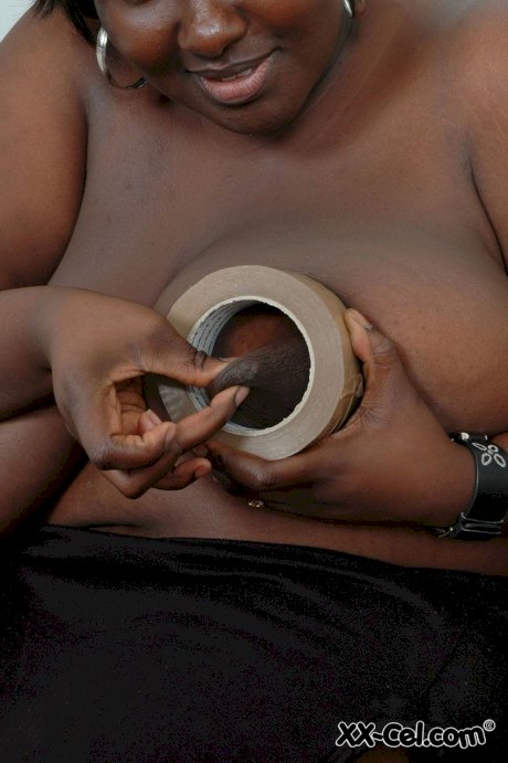 Afro-American BBW Mariana Kodjo wraps her huge tits in duct tape & poses nude