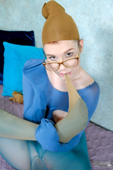 Nerdy redhead Kaira Love models in revealing hose with her glasses on