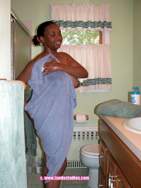 Buxom black babe Charm teases with her big boobs in the bathroom