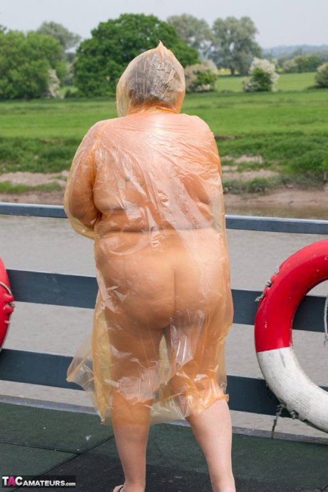 Obese oma Grandma Libby doffs a see-through raincoat to get naked on a bridge