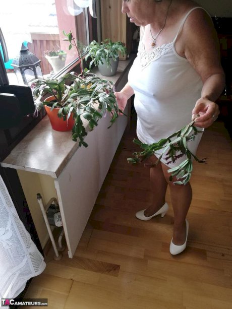 Horny grandmother slides hands down pantyhose to masturbate