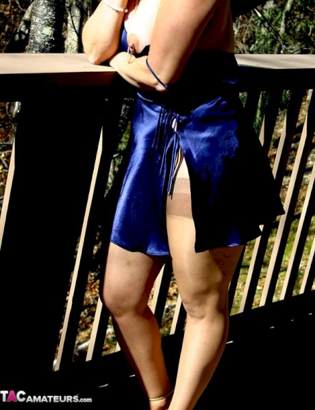 Older amateur Devlynn stick a cigar in her vagina on the back deck