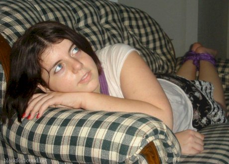 Overweight girl has her hands tied behind her back while her ankles are bound