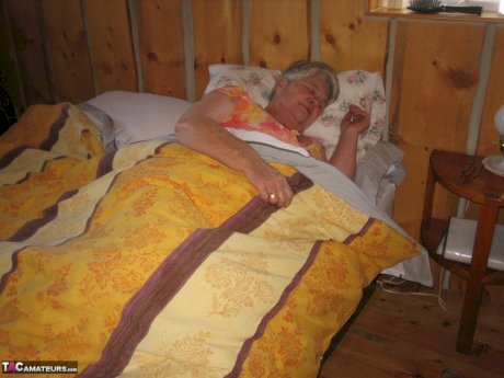 Obese granny Girdle Goddess wakes up from a nap and precedes to strip naked
