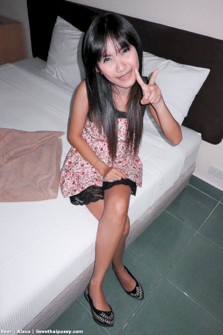 Busty Thai girl Beer gives up her shaved pussy to a sex tourist in hotel room