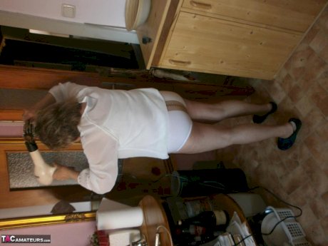 Hairy grandmother slides her upskirt panties aside to expose her vagina
