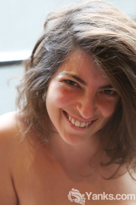 Big boobed amateur brunette Nora getting naked and revealing her bushy beaver