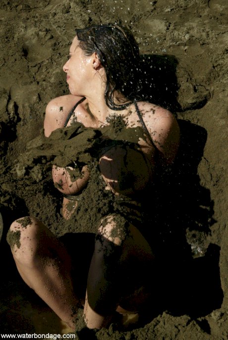 Bound slut with big boobs Sasha Sparks gets buried in mud by her lezdom