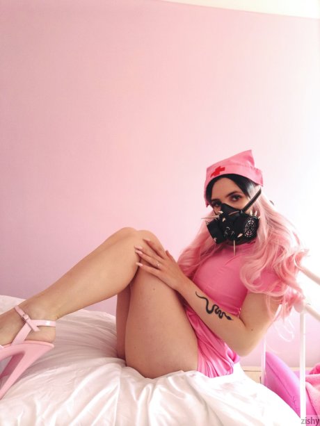 Naughty Quarantine Challenge sheds her nurse costume & poses in a gas mask