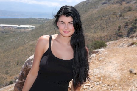 Glamorous brunette babe Lucy teasing with her big tits outdoors