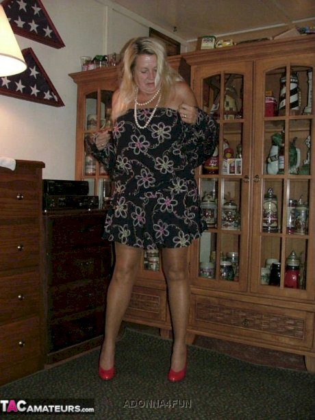 Fat grandmother with blonde hair exposes herself in tan nylons and garters