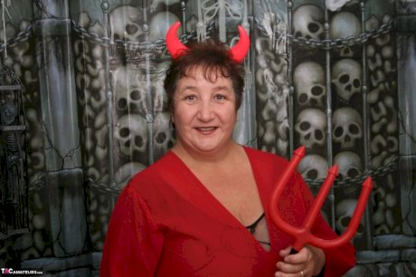 Mature fatty Kinky Carol uncovers her huge tits at Halloween