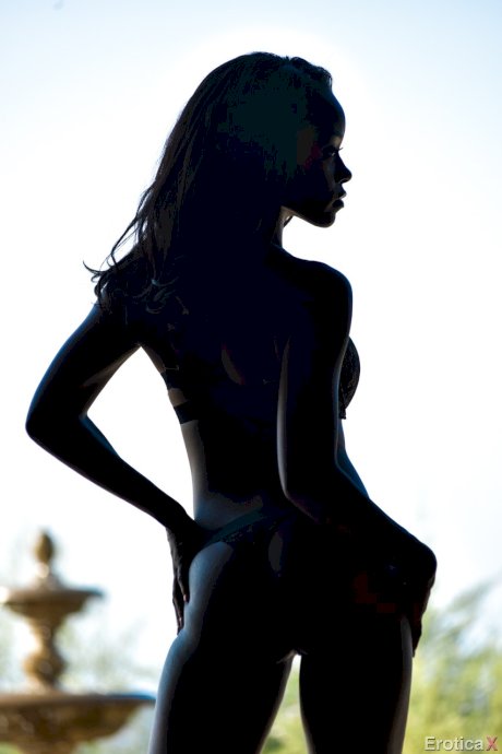 Hot ebony in silhouette Jezabel Vessir moves outside to pose nude on the patio