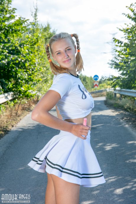 Blonde teen Nana strips to her socks and runners on a paved road