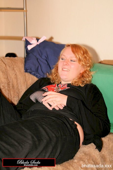 Redheaded fatty strips her sweatshirt and shows her cleavage in a black bra