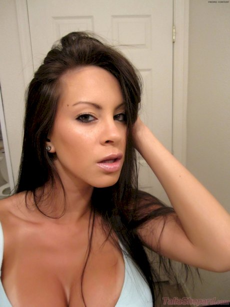 Solo girl Talia Shepard plays with a dildo while taking self shots of her tits