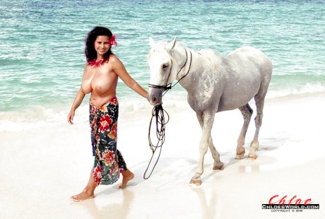 European solo model Chloe Vevrier demonstrating hooters in ocean and on beach