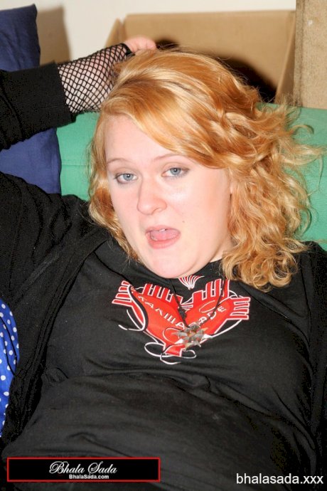 Redheaded fatty strips her sweatshirt and shows her cleavage in a black bra