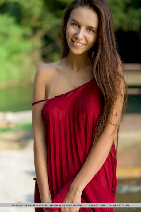 Beautiful teen Alisa Amore disrobes for nude solo poses near a dam