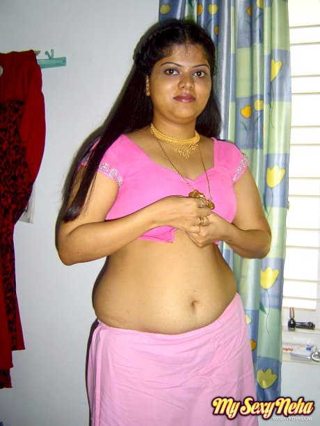 Plump Indian girl Neha gets totally naked on her bed in solo action