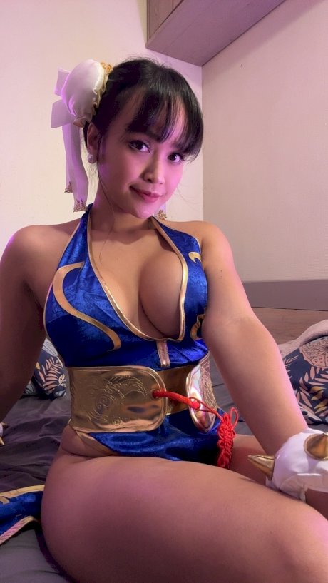 Brunette only fans babe Asian Eye teases with her big cleavage in a hot outfit