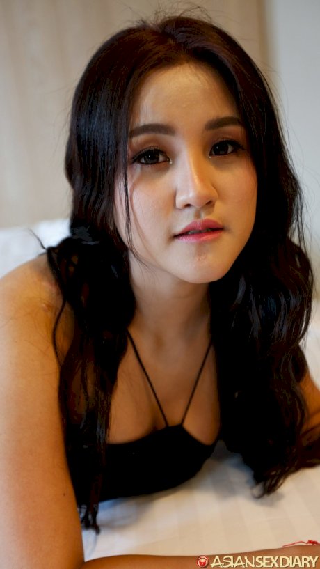 Beautiful Asian girl Zin shows her big tits while undressing for POV sex