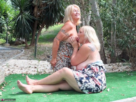 Mature woman Melody and her lesbian lover fondle each others boobs outdoors