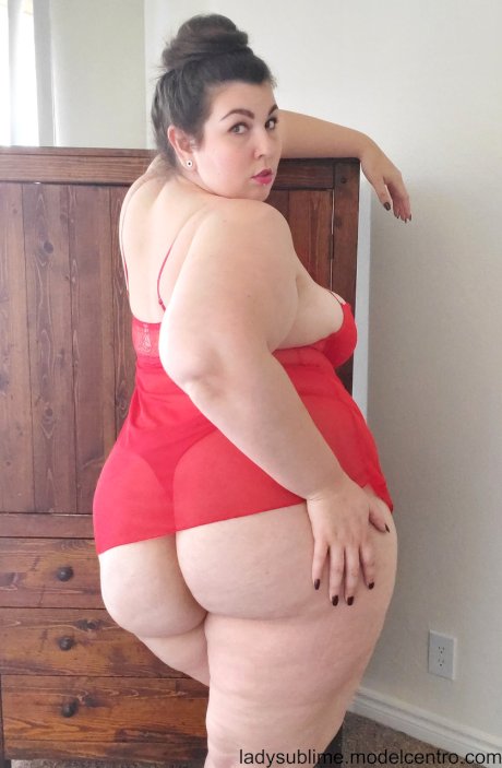 Fatty in a red negligee Lady Sublime flaunts her big juggs while sucking a toy