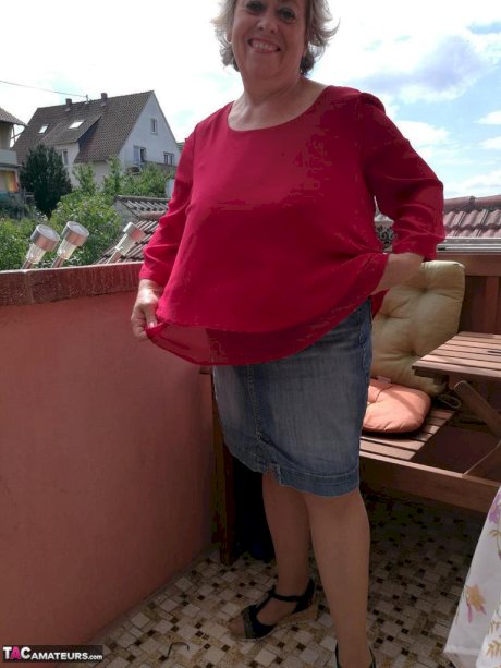 Horny oma spreads her upskirt pussy after pulling down her hose on patio