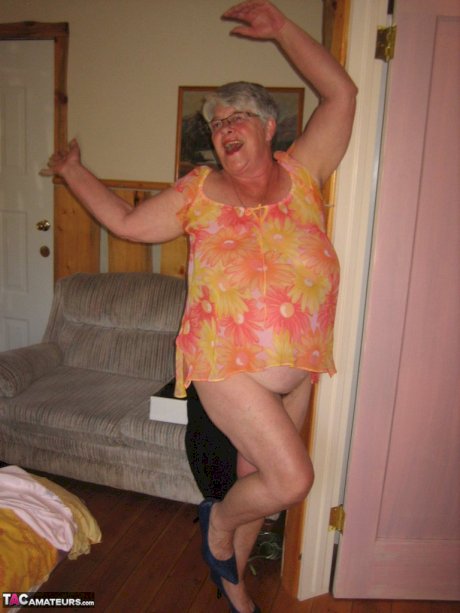 Obese granny Girdle Goddess wakes up from a nap and precedes to strip naked