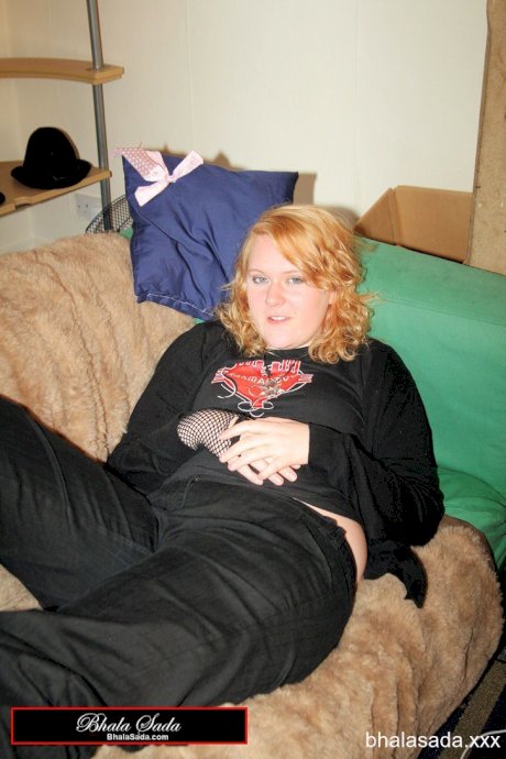 Redheaded fatty strips her sweatshirt and shows her cleavage in a black bra