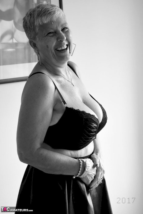 Old woman with short hair and floppy tits dons a strapon in fishnet pantyhose