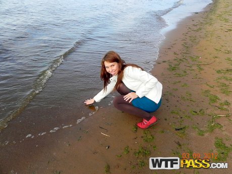 Young redhead pees in beach side car park before making homemade sex tape