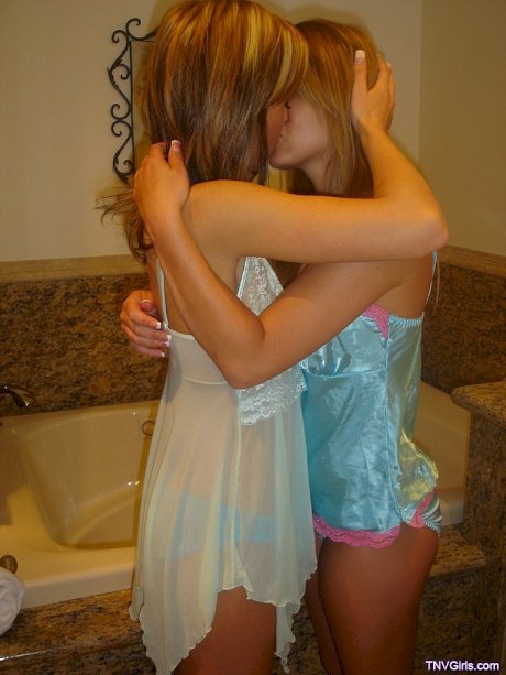 Sexy lesbian teens kiss passionately while showing off their sweet tits